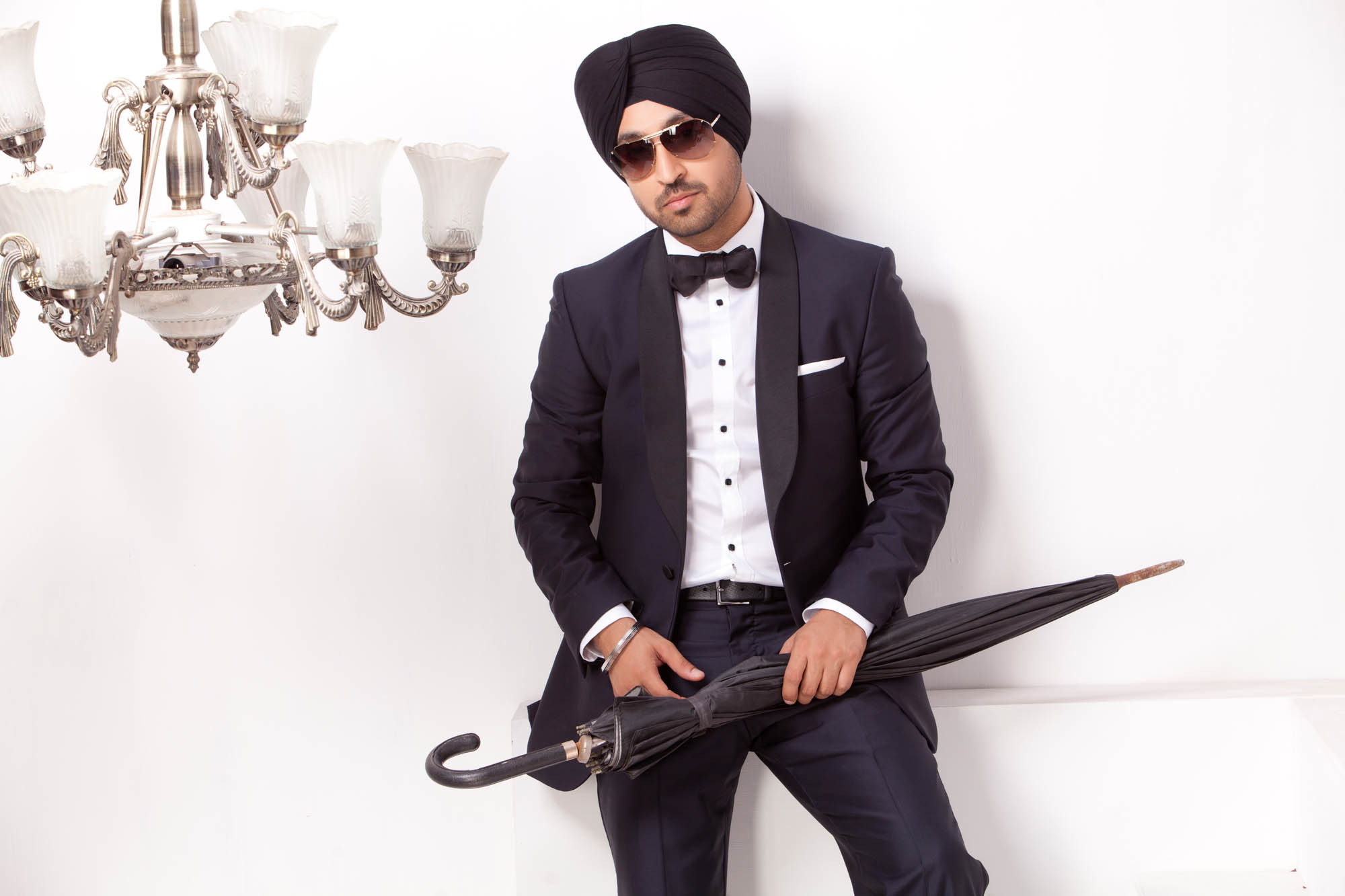 Diljit Dosanjh Photoshoot seated tuxedo portrait with umbrella by Praveen Bhat