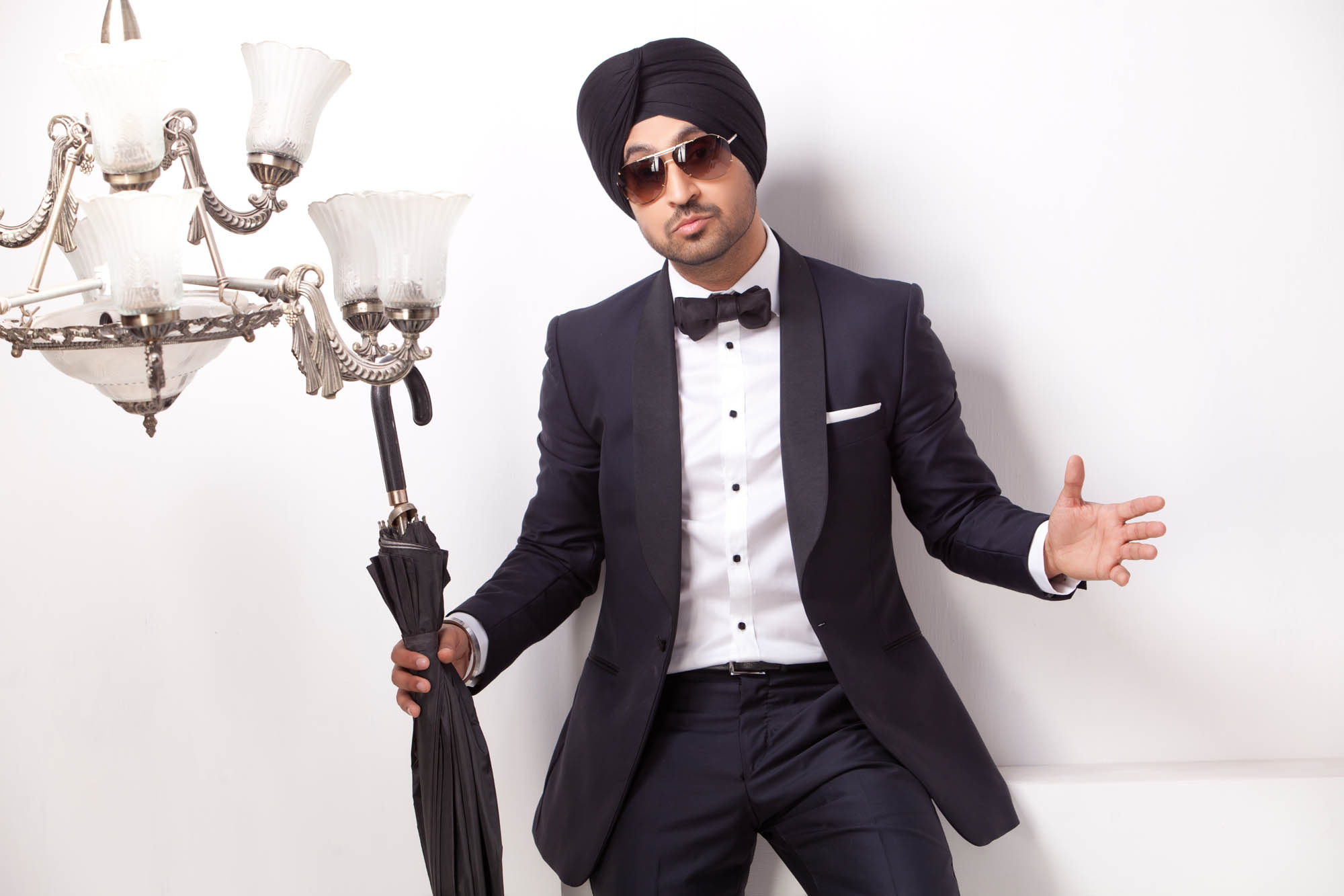 Diljit Dosanjh Photoshoot tuxedo portrait with umbrella and clean white background
