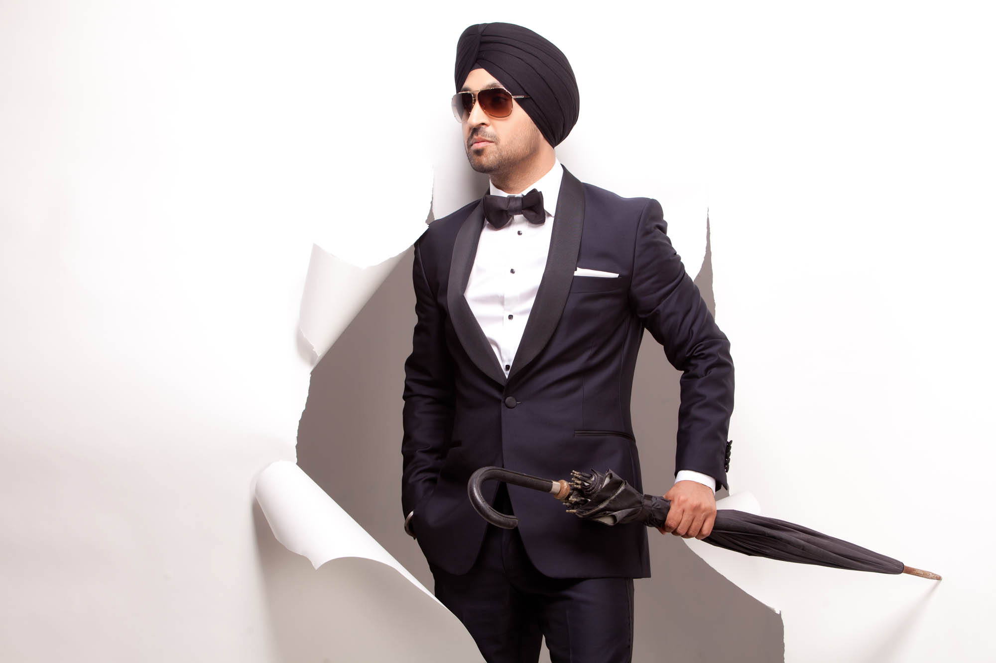Diljit Dosanjh Photoshoot fashion portrait with tuxedo and umbrella